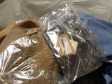 a bag of bread wrapped in plastic sitting on a couch