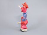 figurine of a woman with a hat on her head and a cigarette in her mouth