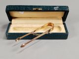 a pair of spoons in a box on a table
