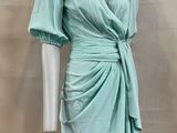 an image of a mannequin wearing a green dress on a mannequin mannequin