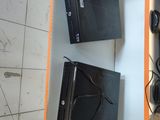 two video game consoles sitting on a shelf next to each other