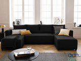 a black couch with yellow pillows in a living room