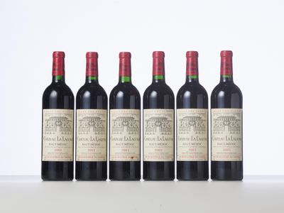 four bottles of red wine lined up in a row