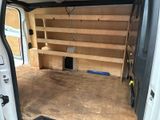 a white van that has some shelves in the back of it