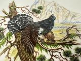 a plate with a painting of a bird sitting on a tree