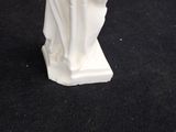 a white statue of a woman holding a baby