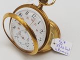 une montre de poche en or sur fond blanc, avec une étiquette de prix