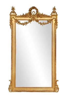a gold framed mirror with a decorative design on it