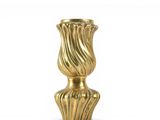 a gold vase that is sitting on a white surface
