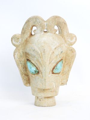 an image of a statue of an alien head with blue eyes