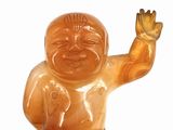 a small statue of a baby with a big smile on it ' s face