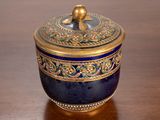 an image of a blue and gold box on a wooden table