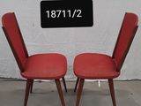 pair of red chairs with black numbers on the back of them