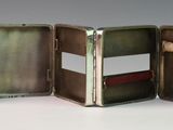 a small metal case with a mirror inside of it