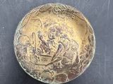 a small bowl with a design on it on a table