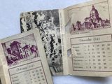 three old calendars sitting on top of each other on a table