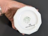 a person holding a cup with a starbucks logo on it