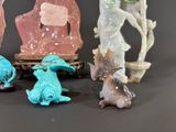 four figurines of different shapes and sizes on a table