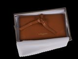 brown leather wallet in a box with a white cloth