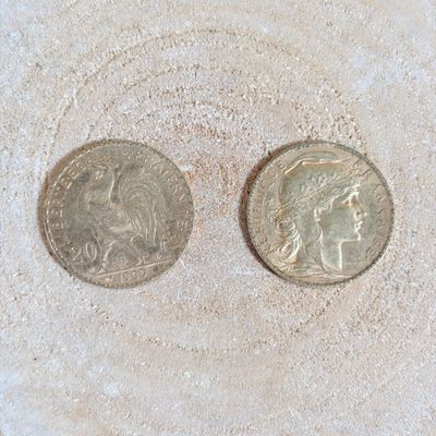 two coins that are sitting in the sand