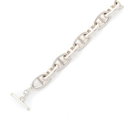 a close up of a silver bracelet on a white background