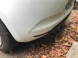 a white car that is parked on the side of the road