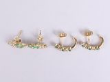 three pairs of gold and emerald earrings on a white surface