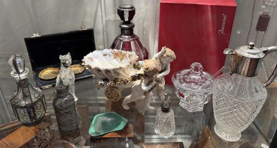 a glass table with a lot of bottles and vases on it