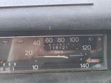 a car dashboard with a speedometer and a clock on it