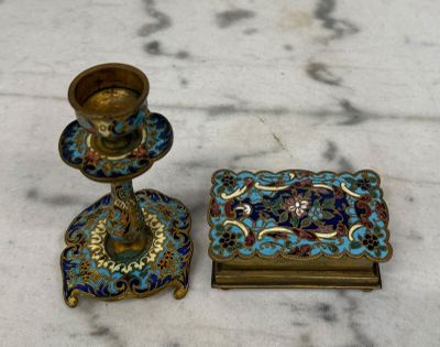 deux bougeoirs et un plateau posés sur une table en marbre