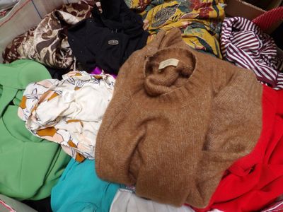 a suitcase filled with clothes and a teddy bear
