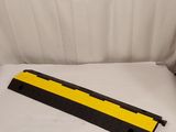 a yellow and black rail on a white sheet