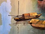 two small boats floating on the water near a building