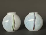 two vases that are sitting next to each other on a table