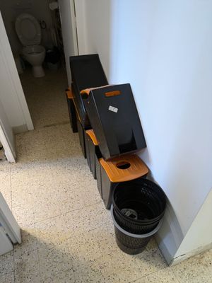 a picture of a bathroom with a toilet and a trash can