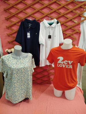three shirts that are on display in a store