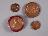 several coins and a coin with a picture of a man on it