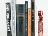 many books that are lined up on a white table