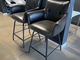 two black leather chairs sitting in a room