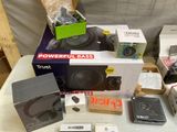 a lot of electronics on a table with boxes on it