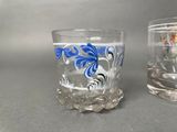 two glasses that are sitting next to each other on a table
