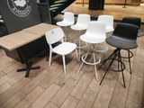 several chairs and a table in a room with wooden floors