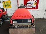a small red machine that is parked in a garage