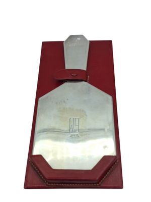 a red box with a silver plate in it