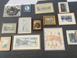 a lot of framed and unframed art on the floor