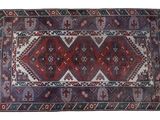 a red and blue rug on a white background