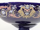 a blue bowl with a gold and blue design on it