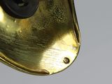 a close up view of a brass bell on a pole