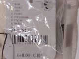 a label on the back of a dress that is wrapped in plastic