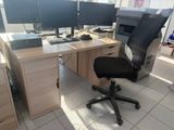 a computer desk with two monitors and a keyboard